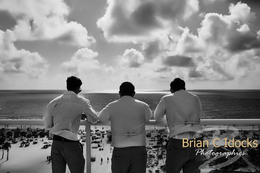 groom overlooking gulf of Mexico- clearwater beach - groom and groomsmen at sunset