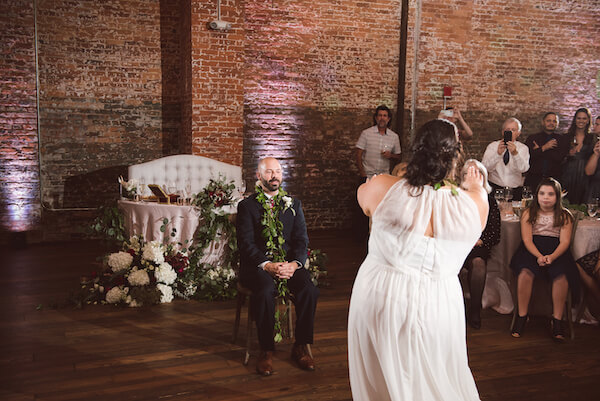 Special Moments Event Planning – Tampa Wedding Planner – Tampa Bay Wedding Planner- Tampa Wedding – Armature Works wedding - bride dancing hula for groom