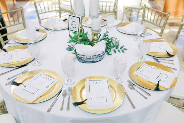 St Petersburg wedding planner - St Petersburg wedding reception - Poynter Institute for Media Studies - gold charger plates - black and white wedding decor - black and white menu cards