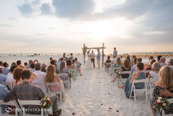 Special Moments Event Planning - Sandpearl Resort - Clearwater Beach Wedding - exchanging wedding vows - bride and groom - sunset wedding on the beach