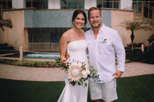 Special Moments Event Planning – Clearwater Beach Wedding – Clearwater Beach Wedding Planner- Clearwater Beach Destination Wedding- bride - groom - bride and groom - white tropical bouquet - groom in shorts - custom Matthew Christopher wedding gown