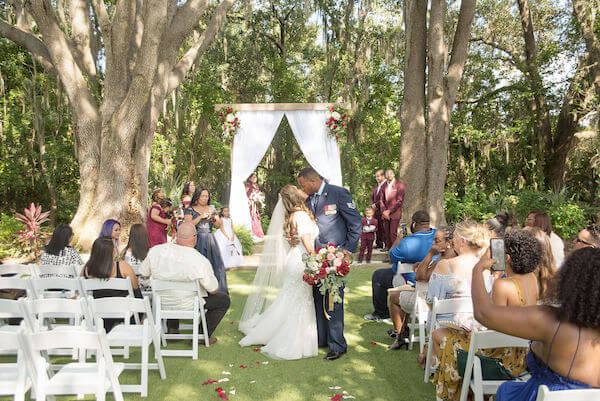 Special Moments Event Planning - Tampa Bay wedding - Secret Garden Wedding - 911 wedding - Military couple - bride and groom - Groom in Air Force uniform - first kiss - signed, sealed, delivered