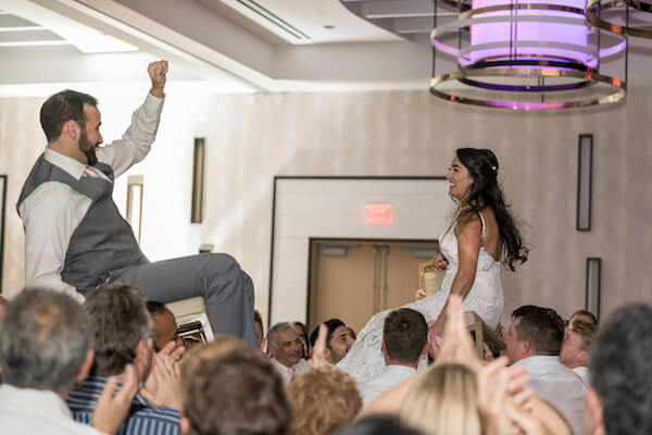 Clearwater Beach wedding - Clearwater Beach - Wyndham Grand Clearwater Beach - Wyndham Grand Clearwater Beach wedding - Wyndham Grand weddings - Clearwater Beach Jewish wedding - blush wedding - Jewish wedding. - Clearwater Beach Jewish wedding - Wyndham Grand Clearwater Beach jewish wedding - Hora - bride and groom being lifted in chairs