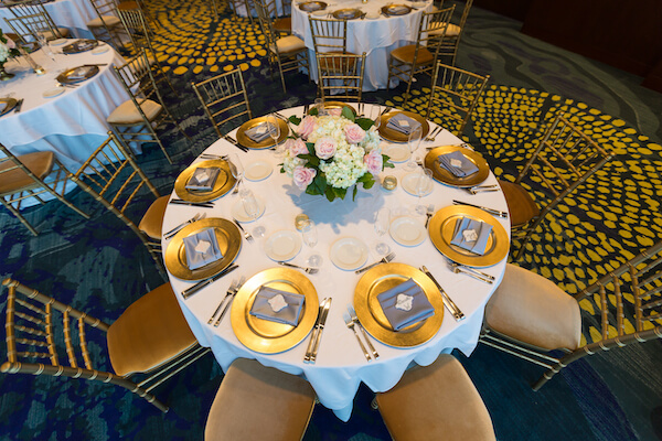 Clearwater Beach Wedding – Opal Sands Wedding – Special Moments Event Planning - gold chivari chairs- gold charger plates- pink and white centerpieces