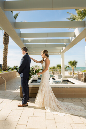 Clearwater Beach Wedding – Opal Sands Wedding – Special Moments Event Planning - first look - bride walking up behind groom