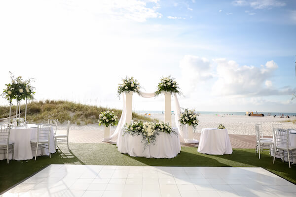 Sandpearl Resort – Sandpearl Wedding – Clearwater Beach Wedding – Greek wedding – Clearwater Beach wedding planner – Special Moments Event Planning - outdoor wedding reception - white dance floor - silver and white wedding - outdoor wedding reception at the Sandpearl Resort - sweetheart table - repurposing your ceremony decor