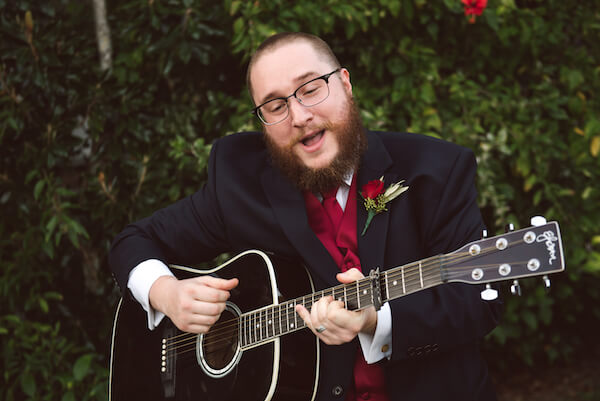 Bradenton wedding – Palma Sola Botanical Park wedding - Special Moments Event Planning - bride's brother paying guitar and singing for their first dance - man of honor - 