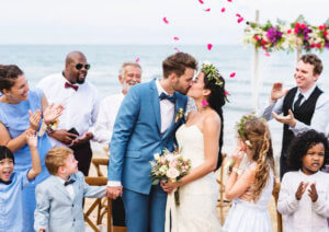 couple kissing at wedding ceremony surrounded by children - children at a wedding - including children in a wedding