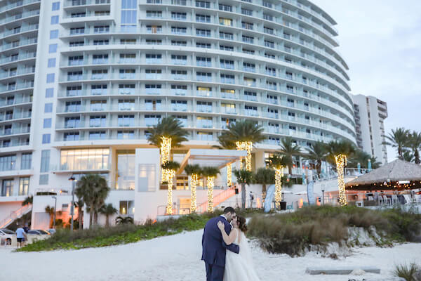 Clearwater Beach wedding  - Opal Sands Resort - Opal Sands Resort wedding - Clearwater Beach - bride and groom walking on Clearwater Beach - just married