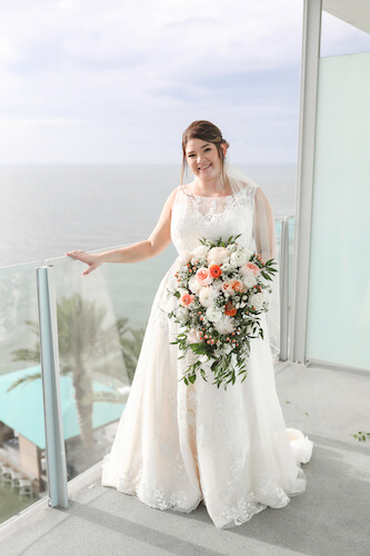 Opal Sands Resort - Clearwater Beach wedding - bride on balcony - peach and pink bridal bouquet