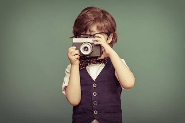 boy with camera at a wedding - including children in your wedding