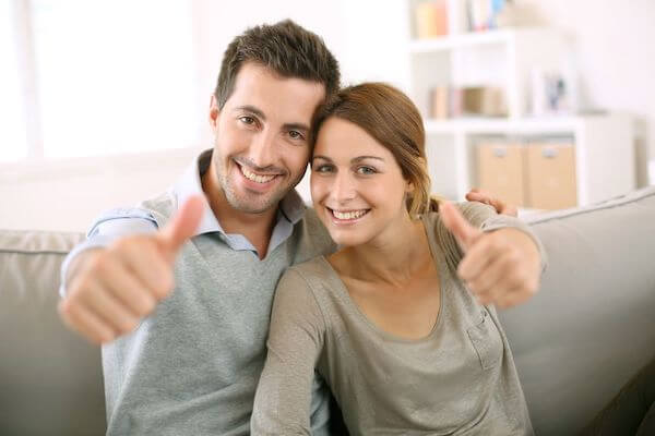 young couple giving a thumbs up- young couple supporting each other - supporting each other through wedding planning