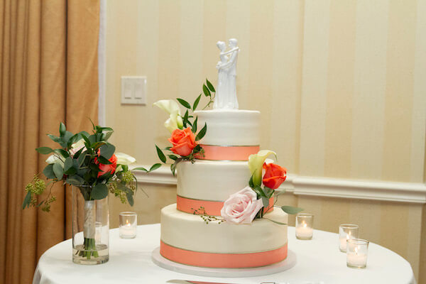 white wedding cake with peach ribbon - three tiered wedding cake - throw away bouquet - anniversary dance