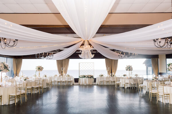 pelican Restaurant wedding - Rusty Pelican Restaurant wedding reception - ballroom with draped ceiling - ceiling drop with twinkle lights- gold and white wedding reception