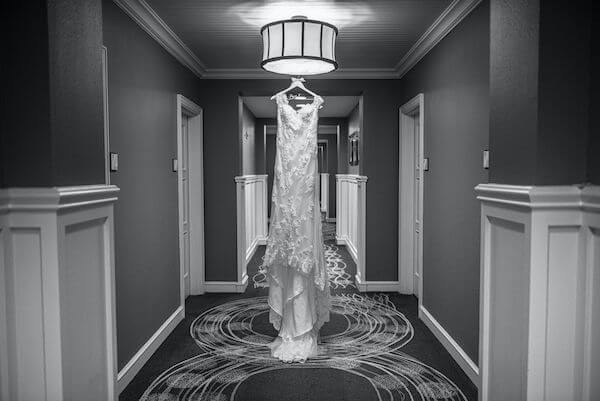 Special moments Event Planning x- Clearwater Beach wedding - Clearwater Beach wedding planner - Sandpearl Resort wedding - lace wedding gown - lace wedding gown photographer hanging in the hotel hallway