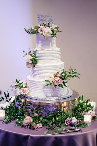 Special moments Event Planning x- Clearwater Beach wedding - Clearwater Beach wedding planner - Sandpearl Resort wedding - wedding cake. - four tiered wedding cake - white butter cream wedding cake - wedding cake on silver cake stand - wedding cake with pink and purple flowers