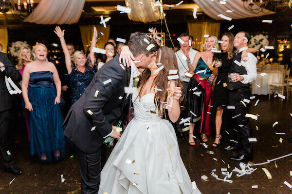 Tampa wedding - Tampa wedding reception - Rusty Pelican Restaurant wedding reception - bride and groom kissing - bride and groom on dance floor - bride and groom kissing on dance floor - bride and groom under confetti shower - confetti cannon 