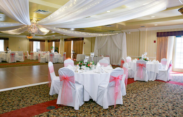 peach and white wedding - draped ceiling with twinkle lights- white chair covers with peach sashes