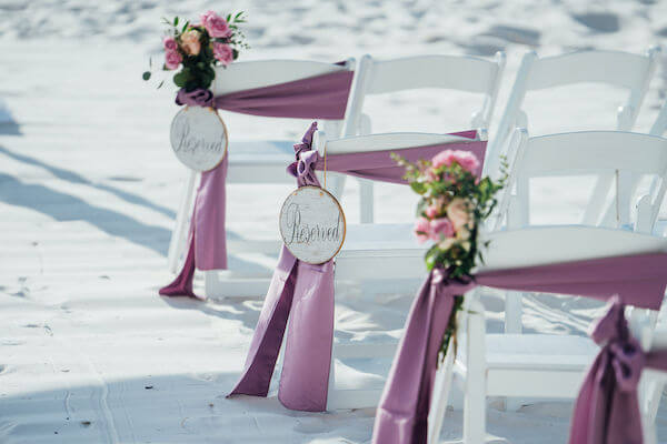 Special moments Event Planning x- Clearwater Beach wedding - Clearwater Beach wedding planner - Sandpearl Resort wedding - ceremony chairs with purple smashes - ceremony chairs with reserved signs - ceremony chairs with purple flowers