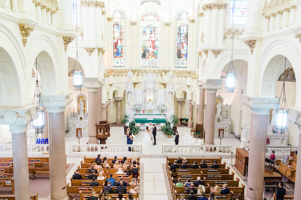 Tampa wedding - Tampa wedding ceremony - Sacred Heart Catholic Church Tampa - wedding ceremony at Sacred heart Catholic Church Tampa - bride and groom - bride and groom exchanging wedding vows - bride and groom exchanging wedding vows in Catholic Church