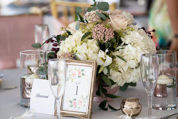 Sirata Beach Resort wedding reception - Coconut Palm Pavilion - Coconut Palm Pavilion wedding reception - pink and white wedding centerpieces - gold table number frames - rose gold votive candles- rose gold wedding decor