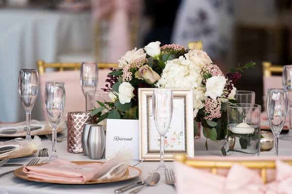 pink and white wedding centerpiece - pink satin napkins - gold chivari chairs - pink chair sashes - gold charger plates - custom menu cards - Coconut Palm Pavilion wedding reception - Sirata Beach Resort wedding reception