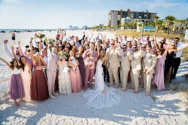 Saint Pete Beach wedding - bride and groom on beach with wedding guests - photo of all wedding guests - wedding guests on beach - Sirata Beach Resort wedding photos