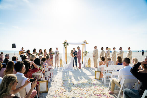 beach wedding ceremony - Sirata Beach Resort wedding ceremony - Saint Pete Beach wedding ceremony - pink and white beach wedding - bride and groom on beach = bride and groom exchanging wedding vows