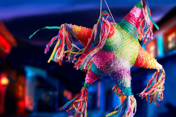 hiring a wedding day coordinator is like swinging blind at a piñata  - a brightly colored piñata