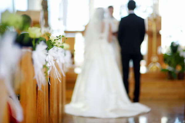 bride and groom standing in church ready to be married