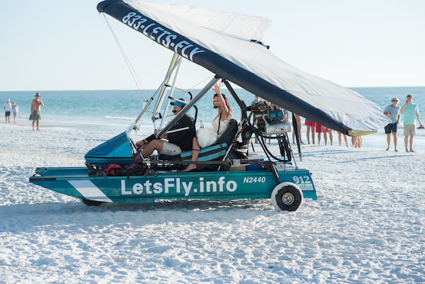 bride arriving at her wedding in a plane - beachfront wedding with brie arriving in a plane