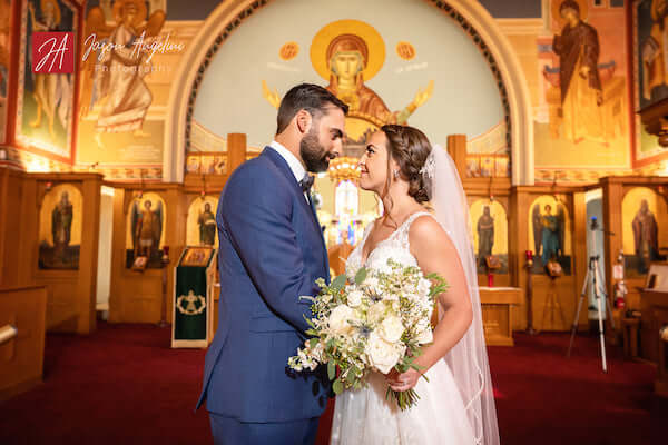 bride and groom pose for pictures after Greek Orthodox wedding during COVID