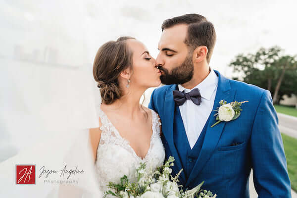 bride and groom kissing next to Tampa Bay