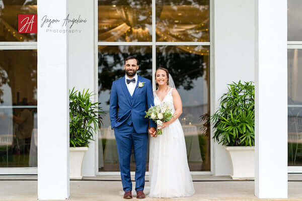 bride and groom pose for photos out front of Tampa Garden Club