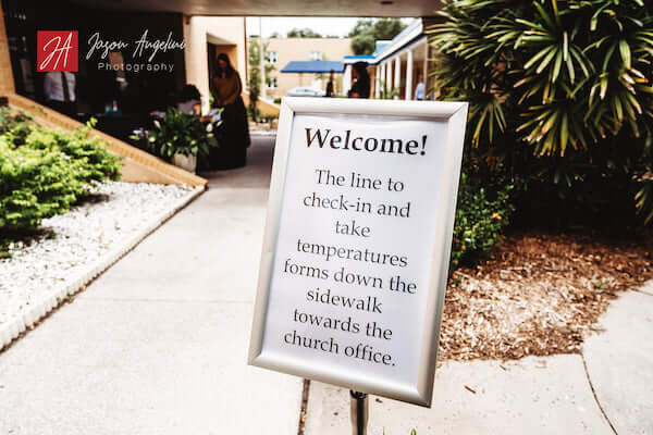 Sign at church sharing COVID precautions for wedding ceremony