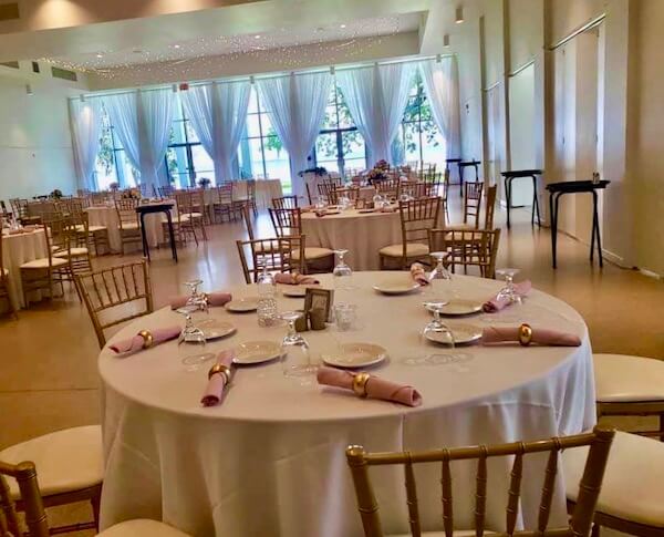 socially distant tables spaced six feet apart at a n indoor wedding reception during COVID-19