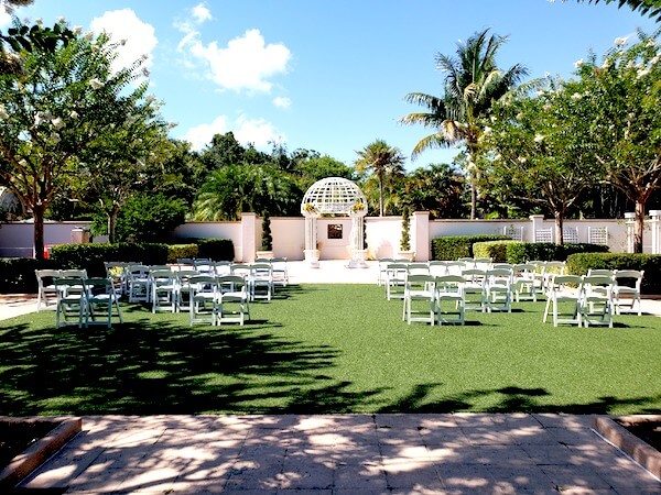 outdoor wedding ceremony with socially distant seating grouping wedding guests by couples and families