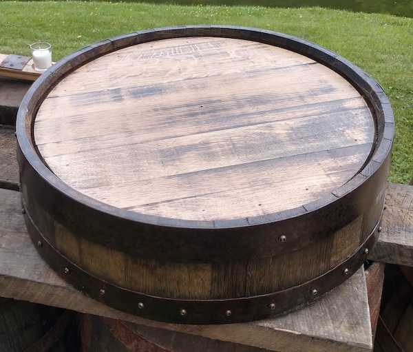 slice of a rustic wine barrel as a cake stand - Tampa weddings – wedding cakes – cake stands – displaying your wedding cake