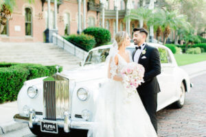 Tampa bride and groom in front of a white Rolls Royce