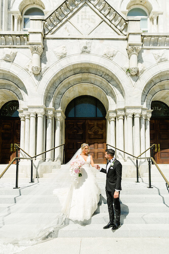 Bride and Groom on the steps of Sacred Heart Catholic Church in Tampa