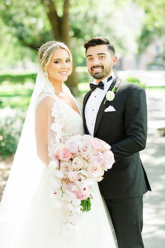 Tampa bride and groom posing for wedding portraits in a park