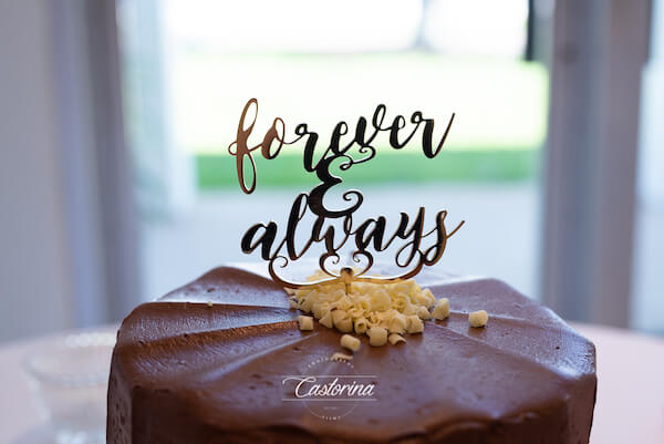 intimate chocolate wedding cake with a gold forever and always cake topper