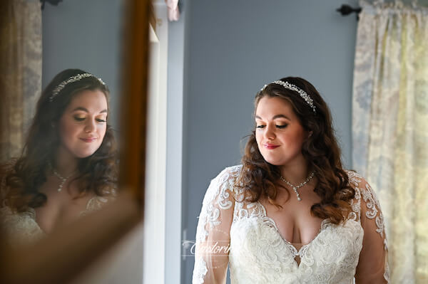 bride looking into a mirror before her Tampa wedding