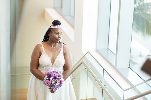 Bride posing for wedding photos on the steps of the Wyndham Grand Clearwater Beach