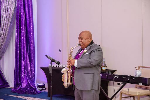 father of the bride playing saxophone at the wedding reception