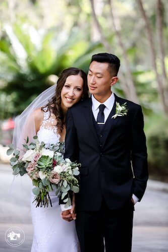 bride and groom snuggling after wedding ceremony