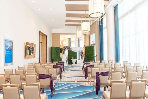 ceremony aisle lined with chairs swagger in purple fabric