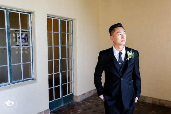 groom in a navy blue three piece suit at Powel Crosley Estate in Sarasota