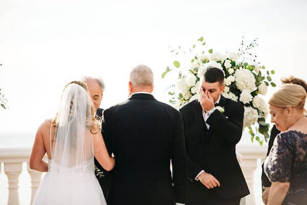 bride walking down the aisle to a tearful groom at the Hyatt Clearwater Beach