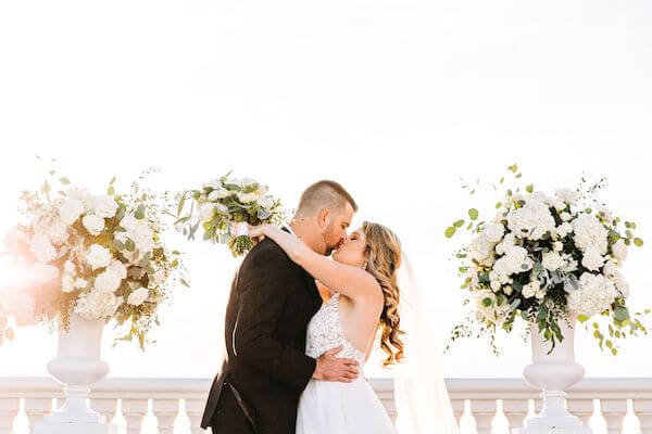 bride and groom kissing at the end of their wedding ceremony on the Sky Terrace at the Hyatt Clearwater beach